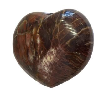 Smooth polished carnelian carved heart palm stone with translucent amber-red tones and natural circular orbicular inclusions isolated on a white background.